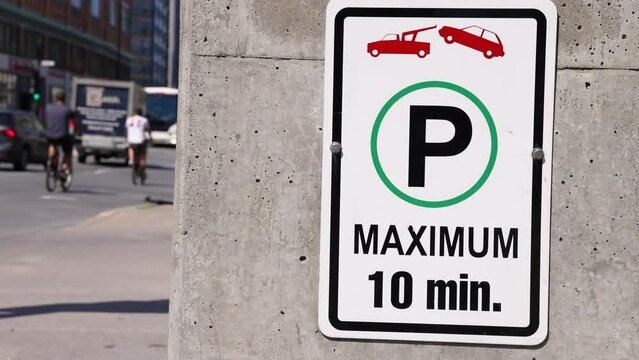 Short movie of a parking sign on a city center street in Montreal, Canada. Depicting a tow truck and maximum 10 minute stay. With copy space.