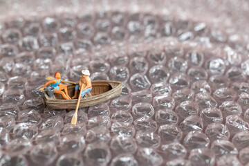 Miniature Couple with boat sailing on pink bubble