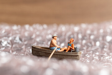 Miniature Couple with boat sailing on pink bubble
