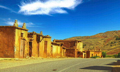 Beautiful abandoned deserted clay houses ghost town berber village, empty road in atlas mountains,...