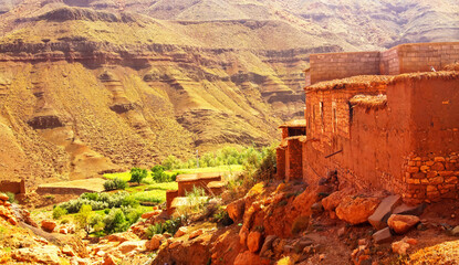 Hiking through idyllic beautiful lonely old clay house berber villages in high Atlas mountains...