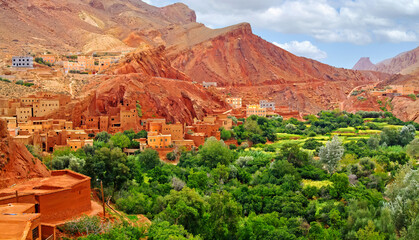 Beautiful moroccan  red mountain valley landscape, green oasis, historical clay stone berber town -...