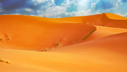 Beautiful empty orange color sand desert dunes landscape, wavy lines, sun rays storm clouds -...