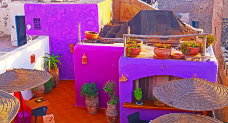 Essaouira, Morocco - September 9. 2011:  Colorful purple moroccan style riad roof top restaurant...
