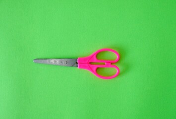 Scissors on a bright green background