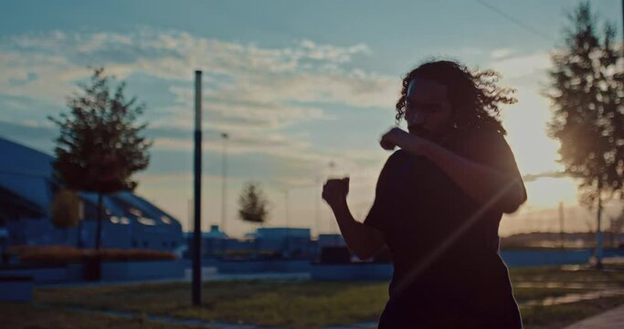 handsom black guy is running and fighting in morning workout outdoors, portrait, 4K, Prores