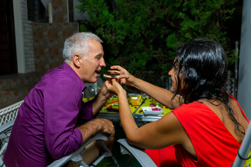 Happy  mature Couple, Mutual care.Smiling couple with sweet food having fun.