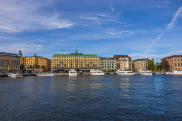Beautiful view of grand hotel in the center of Stockholm on Baltic coast with ships moored to pier. Sweden. Stockholm. 