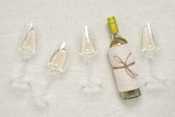 White wine flat lay. Beige textile background. View from above.