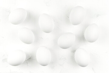 White eggs on a white textured background. Top view