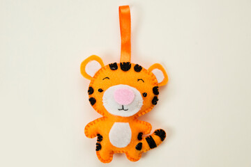 Tiger, symbol of 2022 years. Christmas tree toy handmade from felt. Material for creativity. Deco production.