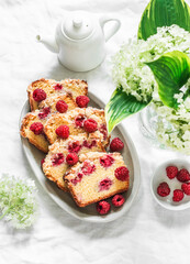 Traditional pound cake recipe with raspberries on a light background, top view