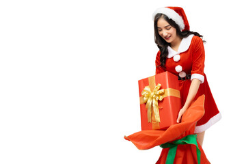 Young woman wearing red santa claus outfit picking up gift box or present from Santa Claus Bag for giving gift isolated on white background copy space Christmas x-mas winter happiness holiday concept