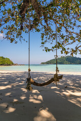 Wooden swing on beautiful white sand beach, Surin island national park, Phang nga, Thailand