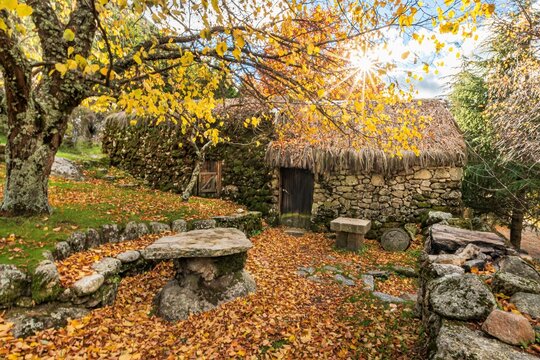 Granit typical rustic old shelter house in the moutains. In the colors of autumn, near river in glaciar valley