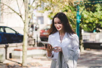 Beautiful white business woman with a tablet in an urban environment