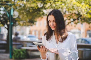 Beautiful white business woman with a tablet in an urban environment