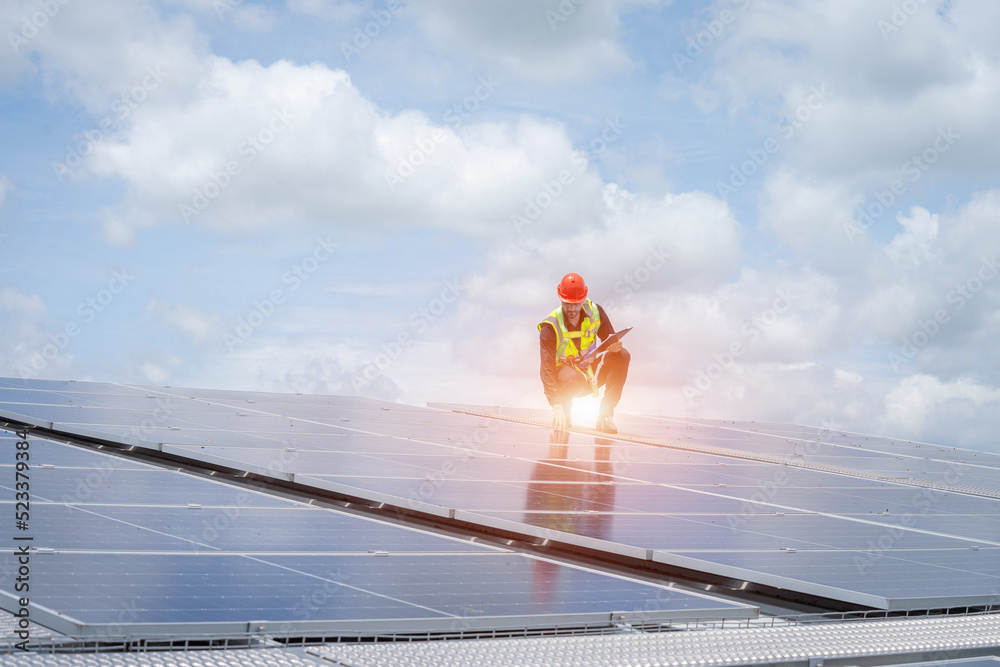 Poster engineers checking solar panel on the roof of factory.