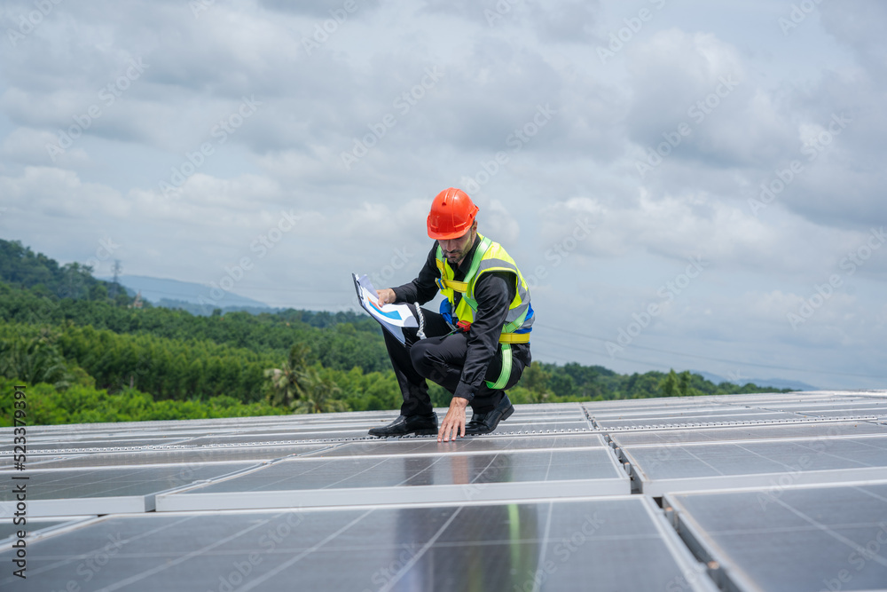 Poster engineers checking solar panel on the roof of factory.