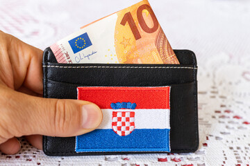Wallet with a protruding 10 euro banknote and the symbol of Croatia, The concept of changing the...