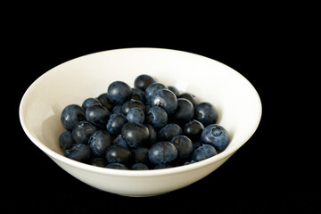 blueberries lie on a black background, harvest