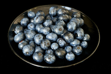 blueberries lie on a black background, harvest