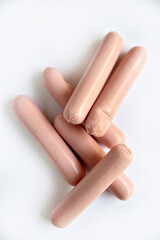 Juicy meat sausages in a group on a white background. Delicious sausages for breakfast.