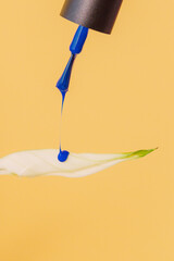 Blue Nail Polish Dripping On White Leaf