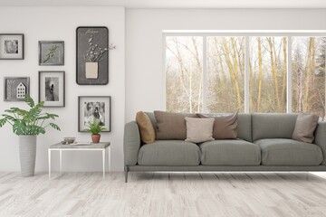 White living room with sofa and winter landscape in window. Scandinavian interior design. 3D illustration