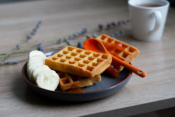 A plate of Belgian waffles on the table