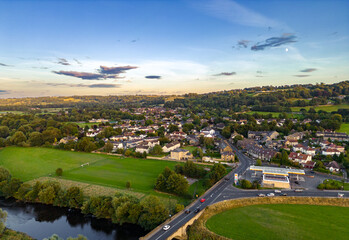 Fototapeta na wymiar Aerial view of Pool-in-Wharfedale, a village in West Yorkshire, shot from a drone at sunset. 