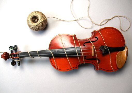 Violin Tied With Rope In Meaning No Music Or Restriction On Gray Background