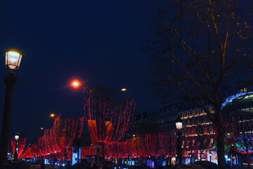 Parisian street in Christmas Night . Paris New Year illumination . Champs Elysees in nighttime