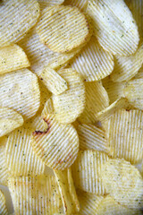 Seasoned fried potato chips close-up. Round potato chips.