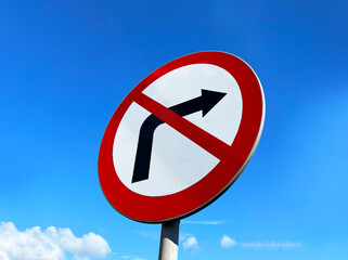Road sign "The direction of movement to the right is prohibited" on the background of blue sky with copyspace