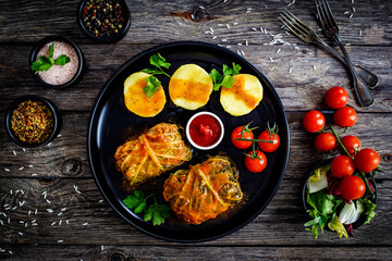 Wrapped minced meat in cabbage leaves and boiled  potatoes - polish dish gołąbki
