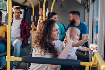 Mother and a baby riding in a bus in the city