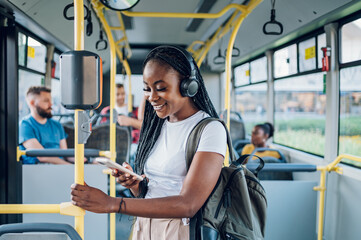 African american woman using smartphone while riding a bus