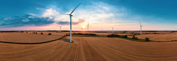 Aerial drone panorama of turbines. Wind Turbine in the sunset seen from an aerial view. Landscape with Turbine Green Energy Electricity, Windmill for electric power production. 