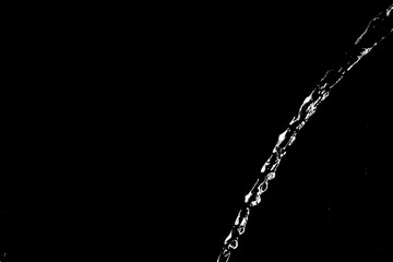 water splashes isolated on black background. white jets with drops