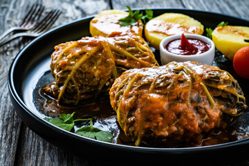 Wrapped minced meat in cabbage leaves and boiled  potatoes - polish dish gołąbki
