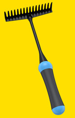 Garden rake with wooden handle for harvesting hay on yellow background.