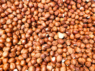 Unpeeled raw hazelnuts background. Top view. 