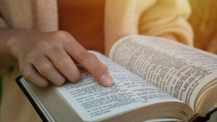 the woman sitting readings Bible a Holy Bible for faith, spirituality With the sunlight in the...