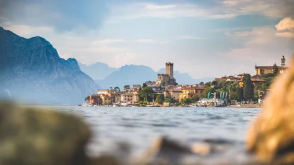 Idyllic coastline in Italy: Blue water and a cute village at lago di garda, Malcesine, sunset © Patrick Daxenbichler