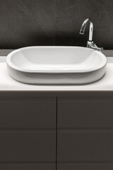ceramic washbasin and water tap in apartment bathroom
