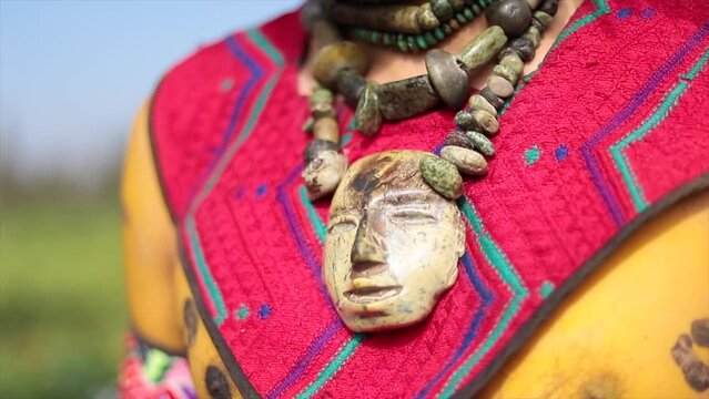 prehispanic aztec textile and necklace close up