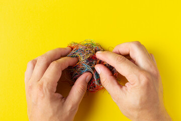 A person untangle a ball of threads with his hands. The concept of solving complex problems. Crime...