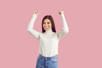 Overjoyed young Caucasian woman isolated on pink studio background show yes gesture. Excited...