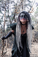 Naklejka premium Forest witch in a pine forest